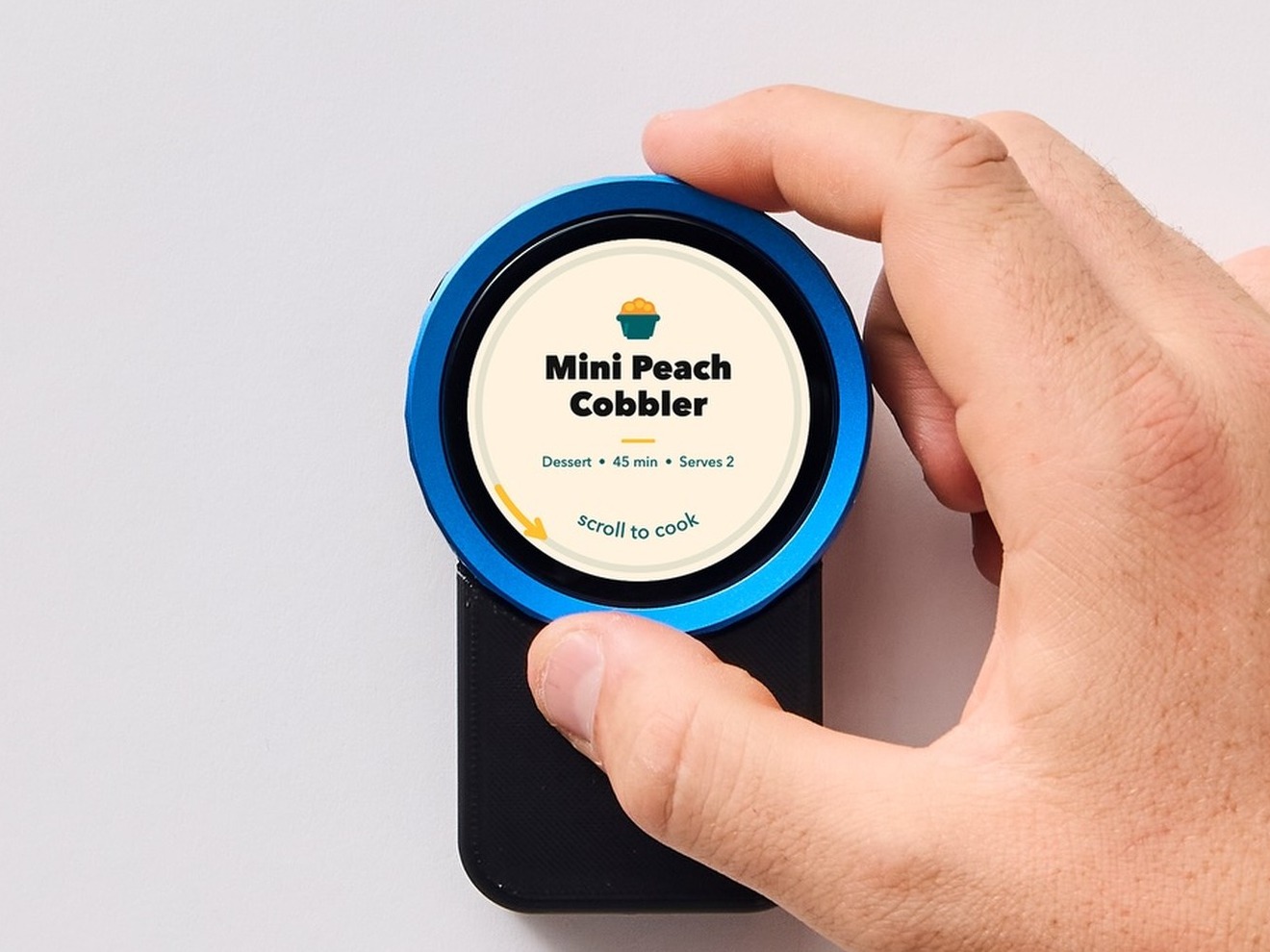 A hand gripping the dial of the Trepo device to turn it